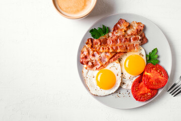 Breakfast with fried eggs and bacon and coffee