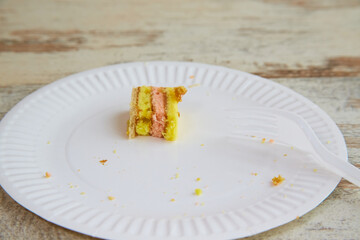The last piece of sponge cake with waffles and jam on a white plate, home baking, fruit sponge,...