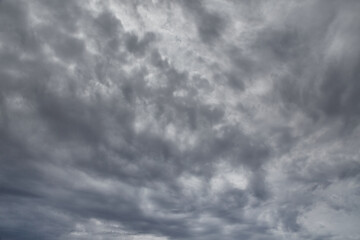 Obraz premium Gray clouds cover the sky, light through gray clouds, gray fall sky, light through a dense shroud of clouds