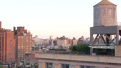 New York City Manhattan skyline cityscape. Rooftop view point, residential district buildings roofs. Real Estate, urban architecture, United States streets. Midtown Chelsea district. Water tower tank.