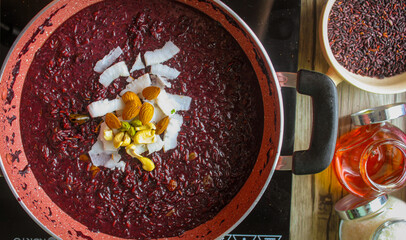 Black rice dessert from north eastern state of India. Freshly chopped coconut and cashew nuts are added.
