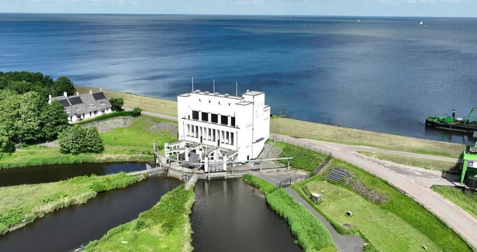 Aerial of the electrically powered pumping station Lely along the Ijsselmeer Lake on a sunny day