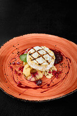 Grilled Camembert Cheese with Berry Sauce on a Rustic Plate
