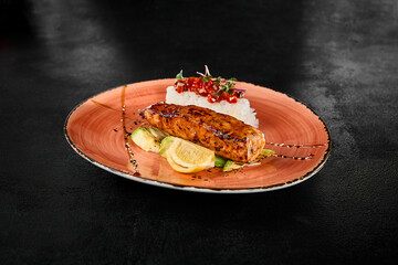 Grilled Salmon Steak with Rice and Garnish on Elegant Plate
