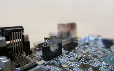 Battery-backed electronic circuit card. 3 Volts lithium cell on the motherboard to feed the configuration memory and real time clock of the device. Focused on the battery.