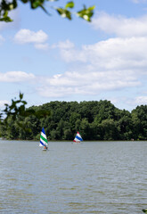Paddle boarding and sailing on a lake 