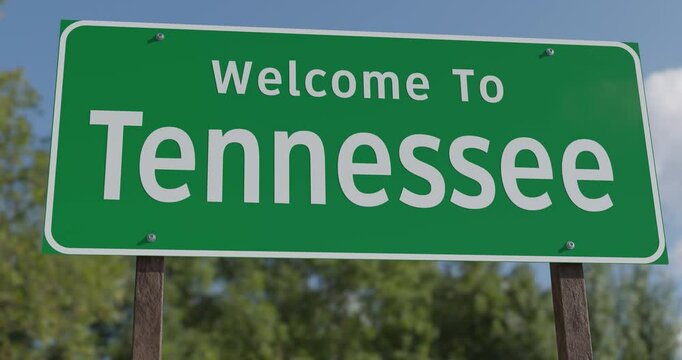 Driving By A Welcome To Tennessee Green Road Sign Against a Blue Sky and Clouds.
