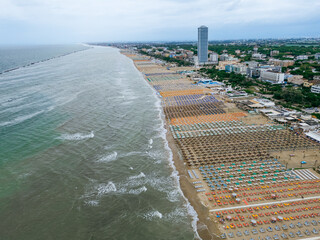 ITALY, 24 June 2024: aerial and panoramic view in 4k of Cesenatico with its beach, its sea and its canal with historic boats. We are on the Romagna coast in the province of Rimini
