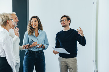 Happy business people discussing a project as a team