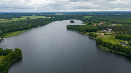 Drone photography of lake, forest and houses near it during summer day