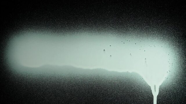 Person using graffiti spray white paint and drawing directly on black glass screen isolated background, opposite view scene.