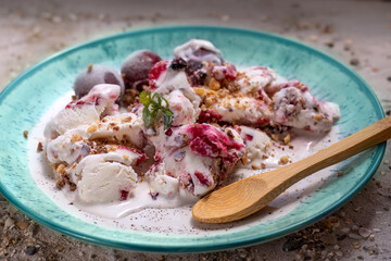 Ice cream with fresh cherries, on turquoise saucer. Homemade dessert