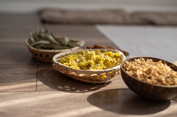 Bowls with dried flowers. Preparation for the practice of creating a mandala from flowers. 