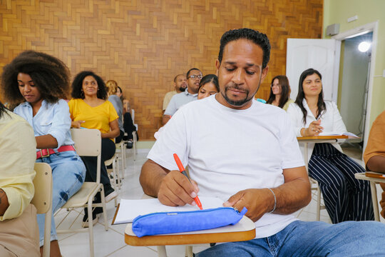 Latino student sitting in the classroom thinking and concentrating on the test.