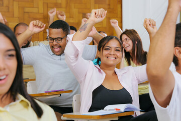 Group of happy students in the classroom celebrating the start of vacation.
