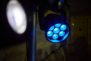 A detailed description of vibrant blue stage lights used for artistic performances