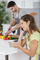 woman using smart phone in kitchen