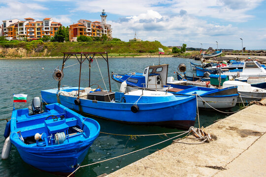 Fishing boats moored at the Aheloy Marina, Marina Cape Hotel with the lighthouse in the background, at Aheloy, Pomorie Municipality, Burgas Province, Bulgarian Black Sea coast