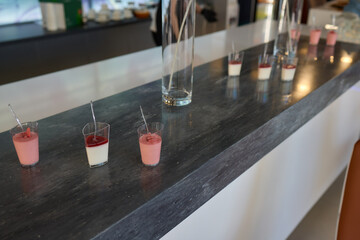 Assorted pastries such as jam tarts and layered desserts beautifully presented on slate trays