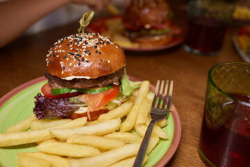 Delicious Gourmet Burgers beautifully presented on a Wooden Board at a Restaurant