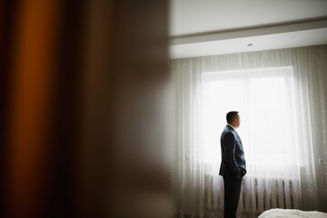 Beautiful man, groom posing and preparing for wedding