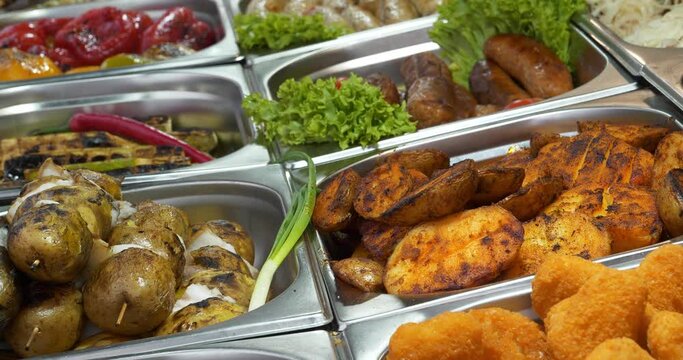 Potatoes cooked in various ways. French fries, deep-fried potatoes, onion, lettuce and other vegetables. Various boiled, fried and deep-fried foods in fast food restaurant