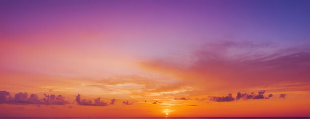 Vibrant sunset sky with fiery orange, pink, and purple hues. Perfect for backgrounds, travel brochures, or adding a dramatic touch to designs.