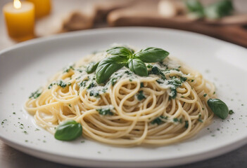 spaghetti with creamy basil sauce in a white porcelain pasta dish, copy space for text, ad shot