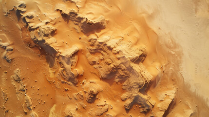 Aerial view of golden sand dunes with intricate patterns and rock formations in the desert