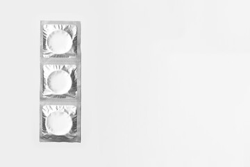 Packaging with condoms on a white background. Contraception. Top view.  Space for text.