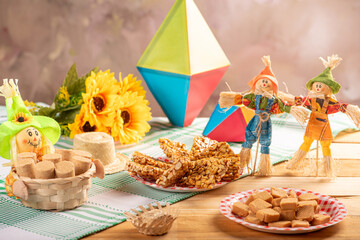Festa Junina, beautiful rustic table with dishes containing various types of sweets for Festa Junina in Brazil, selective focus.