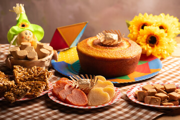 Festa Junina, beautiful rustic table with dishes containing various types of sweets for Festa Junina in Brazil, selective focus.