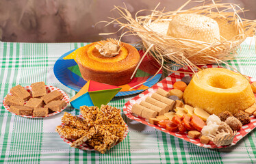 Festa Junina, beautiful rustic table with dishes containing various types of sweets for Festa Junina in Brazil, selective focus.