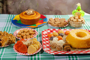 Festa Junina, beautiful rustic table with dishes containing various types of sweets for Festa Junina in Brazil, selective focus.
