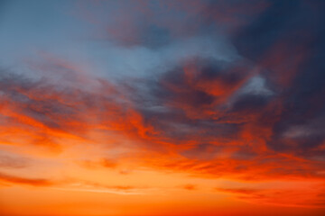  Scenic sunset with clouds in a colorful sky. Beautiful orange and blue sky with clouds. Heaven is filled with clouds and the sun is setting