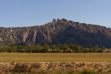 Obraz premium A View of the Montserrat Mountains From a Field in Spain