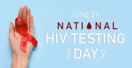 Banner for National HIV Testing Day with hand holding red awareness ribbon