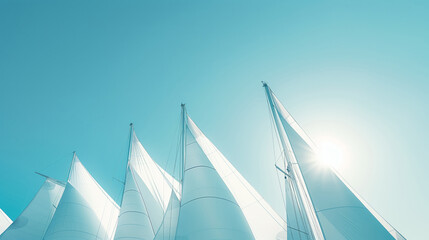 Fototapeta premium Multiple Sails Raised High Against A Clear Blue Sky And Sunlight