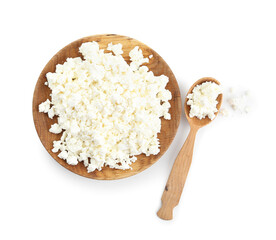 Plate and spoon of tasty cottage cheese on white background