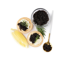 Tasty tartlets with black caviar and lemon on white background