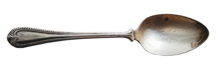 Antique silver spoon isolated. Old tarnished silver spoon, isolated on a white background with slight reflection.