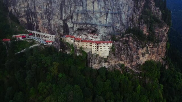 Aerial of the Sumala Monastery in Trabzon, Turkey surrounded by a big cliff and forests