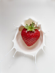 Strawberry falling into Cream with a Splash