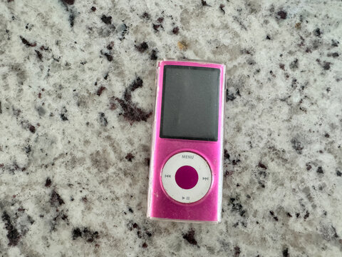 Temple, Texas - June 22, 2024: A vintage Apple iPod Mini, pink, mp3 player from the mid-2000s