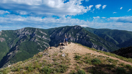 Fototapeta premium Man on Edge of Peak Summer Hiking views in the Mountains of Snowbasin Huntsville Utah 