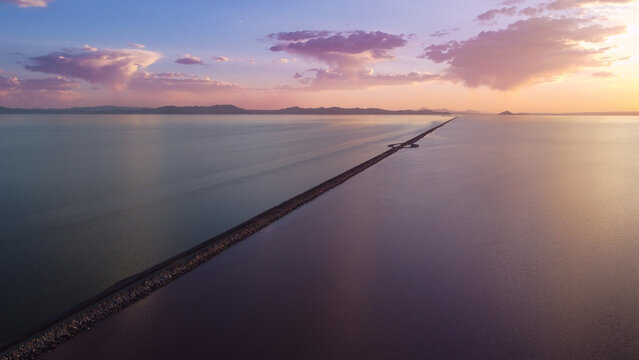 Sunset Aerial Views of the Great Salt Lake Lucin Cutoff Divide Pink Water Contrast with Single Railroad Track Causeway 