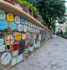 Wall in Alassio adorned with small tiles with signatures of famous people