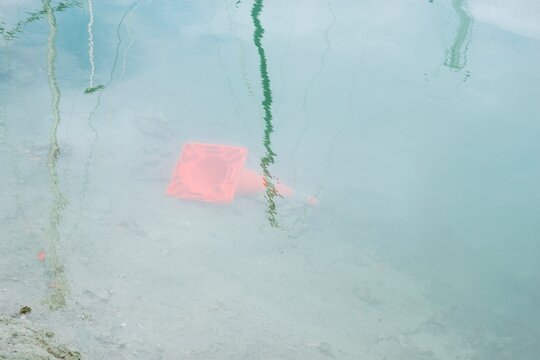 sunken traffic cone in the water