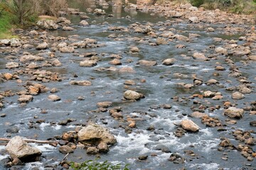 water flows over the rocks in a river in the mountains, the ohenemuri river