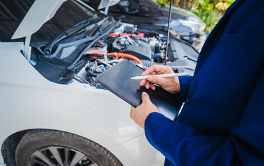 businessman in suit discusses claim with car auto insurance agent. review car damage and complete...